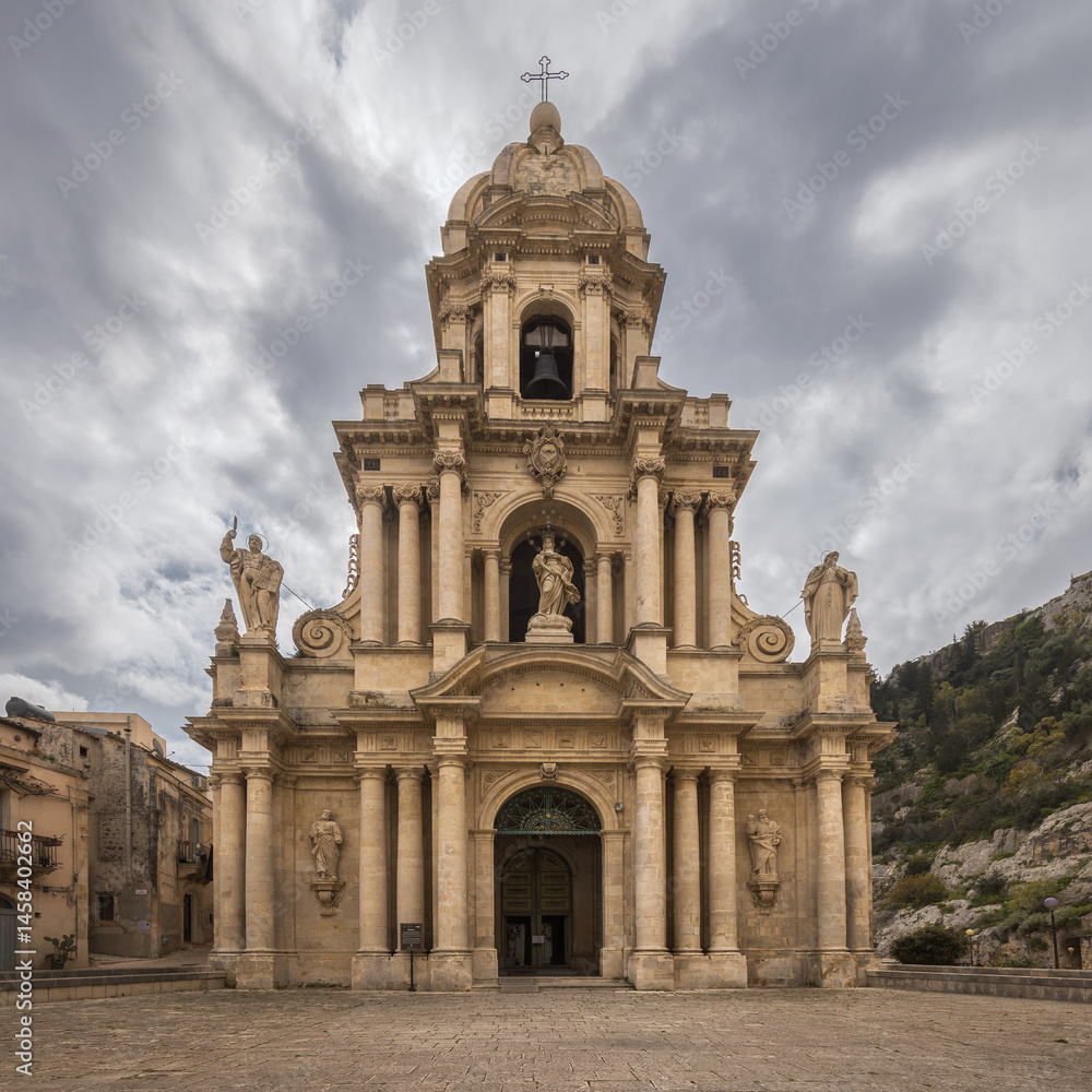Fototapeta premium Majestic Church of Saint Bartholomew Stands Under a Dramatic Sicilian Sky in Scicli, Italy