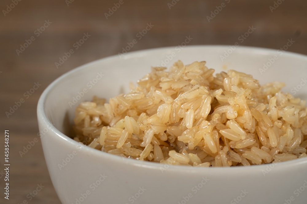 Close up of boiled rice berry in bowl on wooden table. Rice berry on background. Food and healthy concept. Close up of boiled rice berry in bowl on wooden table. Rice berry on background. Food and healthy concept.
