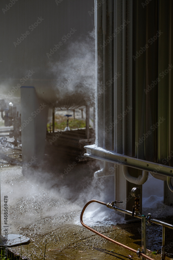 An oxygen station that produces and supplies medical oxygen to a hospital. The station includes radiators and a large white cylinder containing liquefied oxygen for distribution.