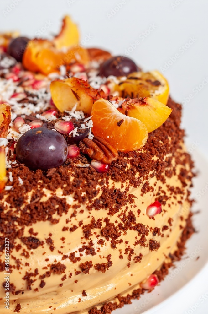 A beautifully decorated cake with fresh fruits, chocolate shavings, and creamy icing, perfect for any occasion.