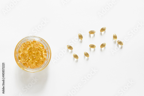 Photos capsules in glass bowl, brown pill of omega 3 fish oil, lecithin or vitamin D oi