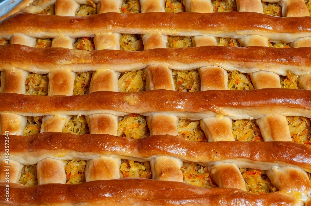 Close-up of a homemade savory pie with a beautifully crafted lattice crust, freshly baked.