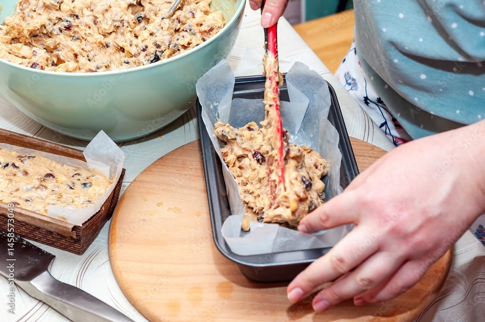 Preparing homemade fruitcake batter in a loaf pan, ready to bake and enjoy for the holidays.