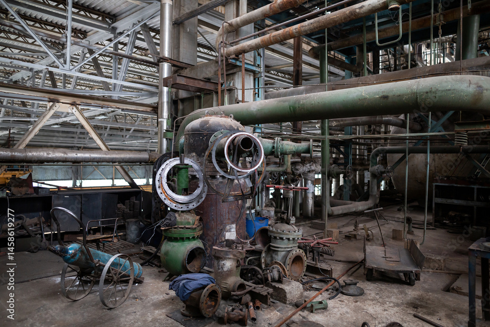 Disassembled industrial valve undergoing maintenance and repair. The metal casing, bolts, internal components are arranged on a workbench, showing detailed mechanical parts and structured engineering