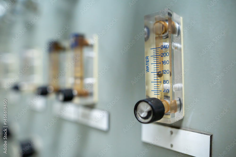 Flow meter used to measure the flow rate of water, featuring a transparent body with a scale from 0-240 CCM. Equipped with a knob for manual flow adjustments, it is part of an industrial control panel