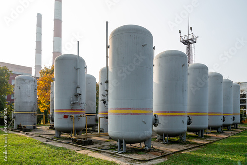 Large industrial tanks used for storing carbon dioxide at a facility. Connected pipes and valves ensure controlled gas distribution and safe storage in an industrial setting.