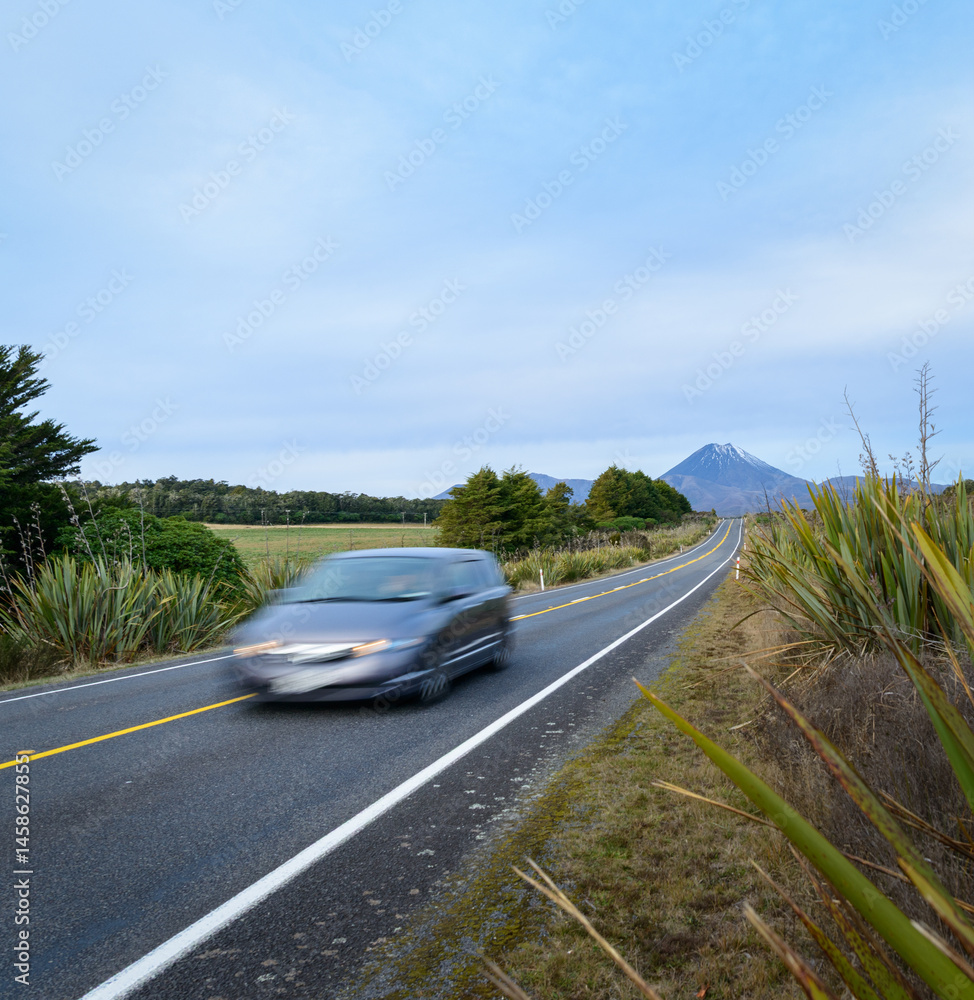 Fast speed driving car motion blur on the road. Mt Ngauruhoe in the distance. Tongariro National Park. New Zealand.