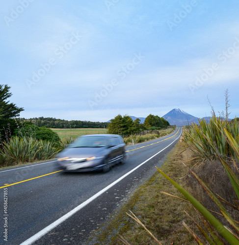 Obraz na płótnie Fast speed driving car motion blur on the road. Mt Ngauruhoe in the distance. Tongariro National Park. New Zealand. w salonie
