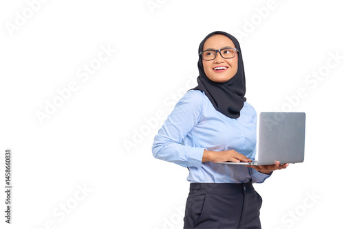 Portrait of smiling young Asian woman holding a laptop and looking away isolated on transparent background