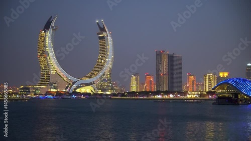 Doha, Lusail city, Qatar - February 1, 2025: Crescent tower from Al Maha Island in Qatar, with a brightly colored sky before sunset