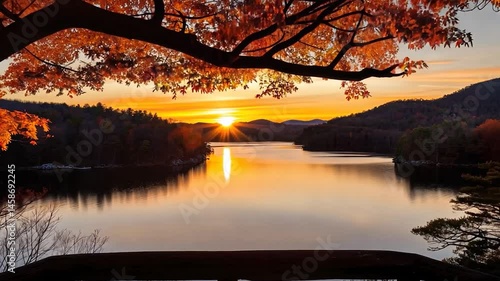 Autumn sunrise over a calm lake from a viewpoint.