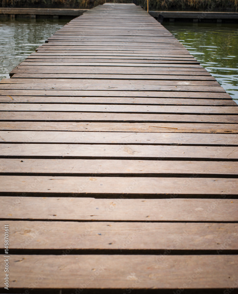 Fototapeta premium Wooden walkway on the lake, closeup of photo.