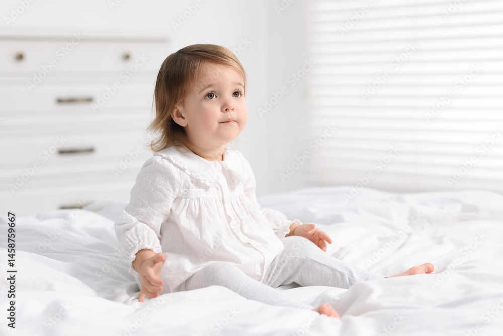 Cute little baby girl on bed at home. Space for text Cute little baby girl on bed at home. Space for text