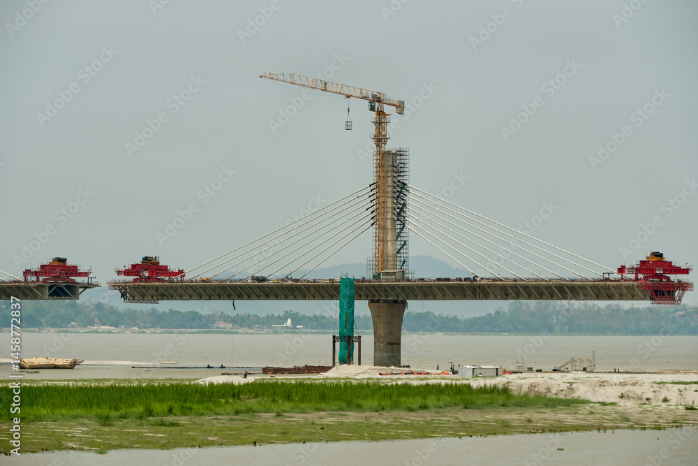 Fototapeta premium Launching gantries at the ends of bridge segments of a cable stayed river bridge under construction