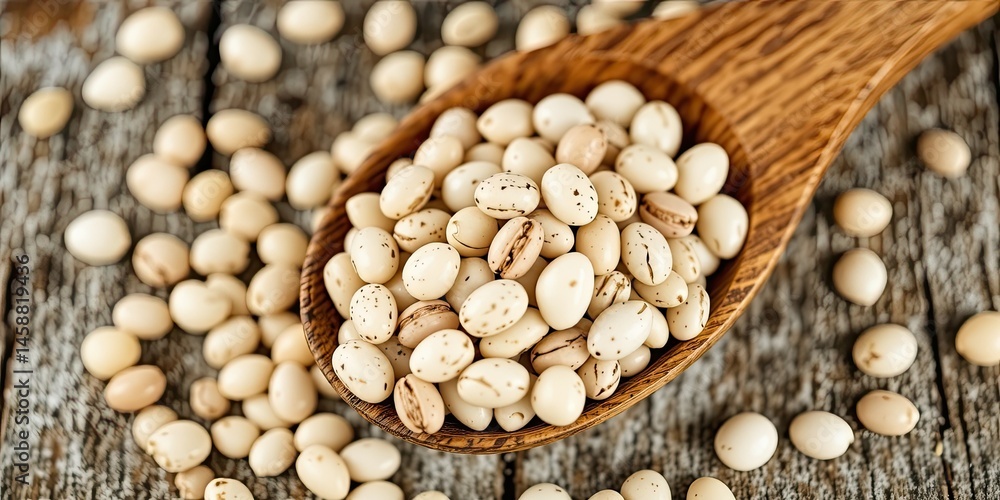 Fototapeta premium Rustic Wooden Spoon and Dried White Beans