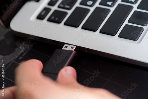 Fényképezés Hand inserting Flash drive memory drive plugged into a computer laptop port