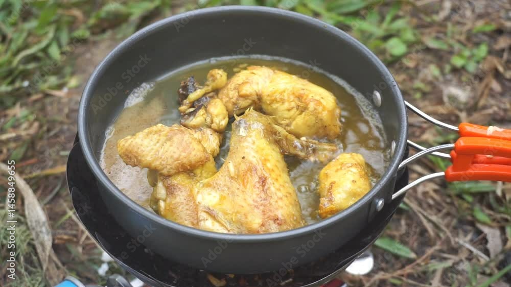 frying chicken wings in a portable stove pan while camping frying chicken wings in a portable stove pan while camping