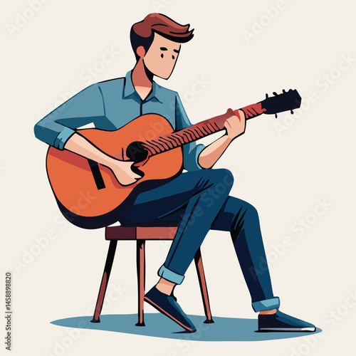 Young man plays acoustic guitar while casually sitting on a simple wooden stool indoors