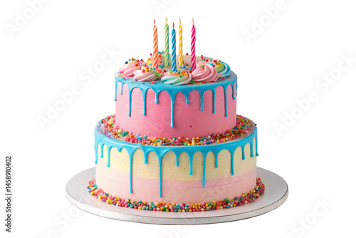 Festive two tiered birthday cake with colorful frosting sprinkles and lit candles against a black