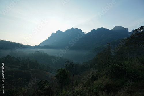 Morning light emerges over Doi Luang Chiang Dao, Chiang Mai, as fog drifts through green forests breathtaking tourist spot for nature lovers seeking fresh air and peaceful relaxation In Thailand.