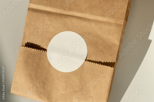 Obraz na płótnie Brown paper bag with circular cutout on plain background w salonie