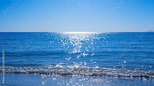 Sparkling ocean waves gently lapping the shore under a vibrant blue sky, sunlight reflecting brilliantly on the water's surface creating a mesmerizing scene of serenity and peace. : Generative AI