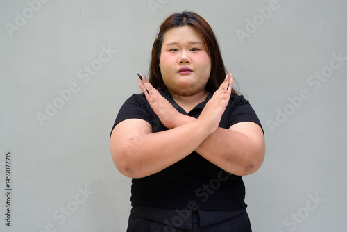 Fotografi Portrait of a young overweight beautiful Asian woman showing stop gesture for re