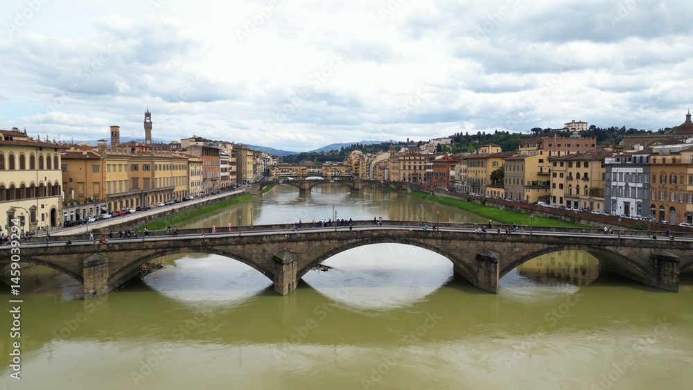 Fototapeta premium Europe, Italy, Florence , drone aerial view of Florence and Arno river - the Old Bridge , Ponte Vecchio , in city downtown of the Middle Ages and Renaissance art - Tourist attraction destination