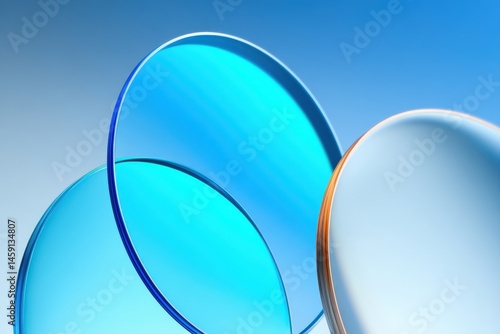 Obraz na płótnie Three overlapping blue-tinted glass discs against a gradient blue background create an abstract, modern composition. w salonie