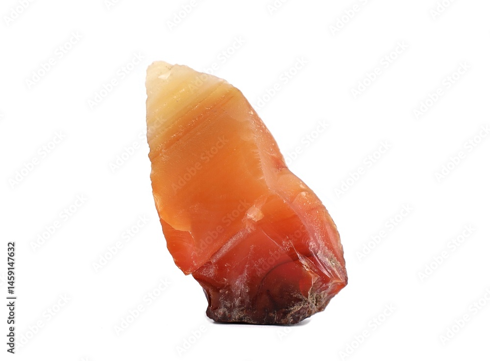 Foto Single orange reddish raw carnelian on white background