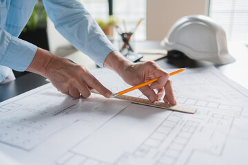 Architecture drawing on architectural Creative project business building construction?Industrial engineering. Close up of female architect working with blueprints, cadastral maps and city plans