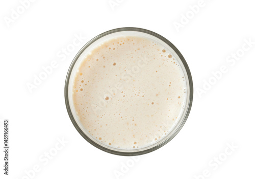 Creamy white drink fills glass with bubbles viewed from above