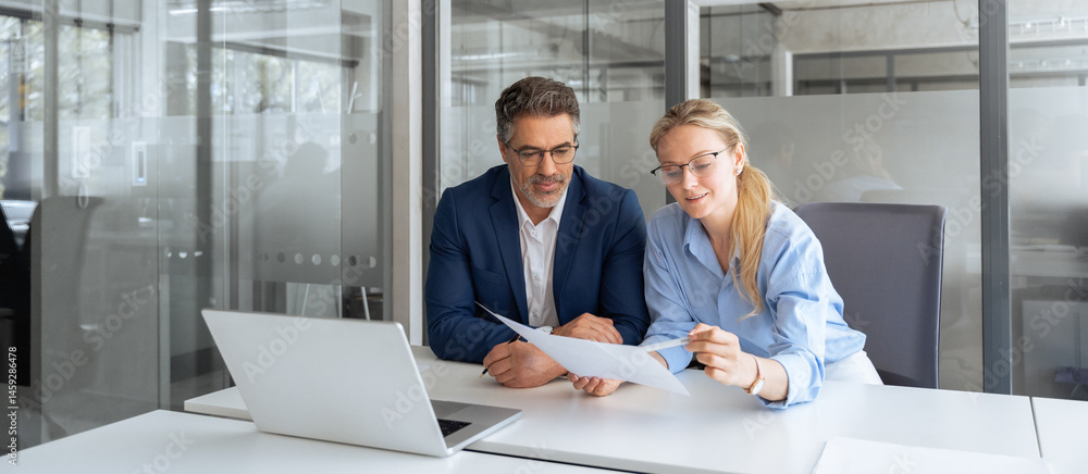 © Stock 4 You - Team of partners mature man and young woman discussing financial banking document report sitting at table in office. Two colleagues professional business people working together on project. Copy space © Stock 4 You - Team of partners mature man and young woman discussing financial banking document report sitting at table in office. Two colleagues professional business people working together on project. Copy space