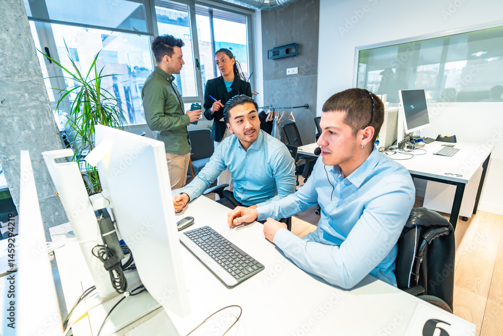 Customer service representatives working in busy call center with diverse team