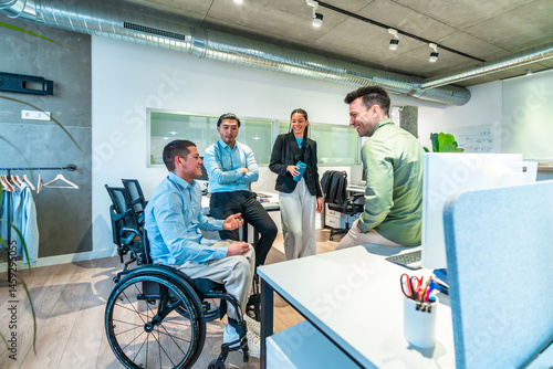 Obraz na płótnie Diverse business team collaborating in modern office, wheelchair user leading discussion w salonie