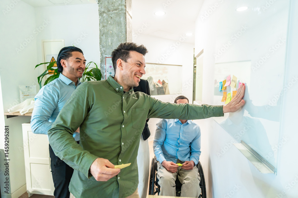 Managers using sticky notes on whiteboard during brainstorming session