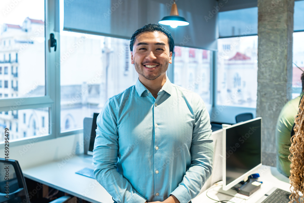 Confident asian businessman smiling in modern office environment