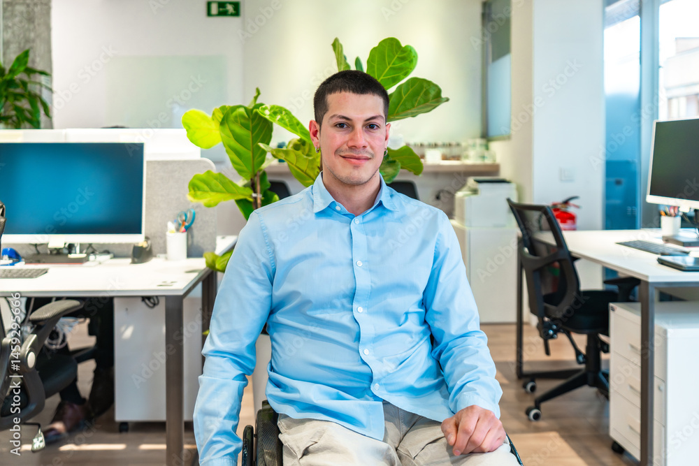 Confident businessman in wheelchair smiling in modern office