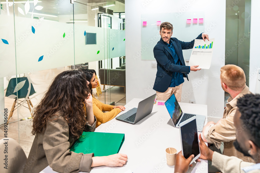 Marketing manager showing charts and statistics during corporate meeting