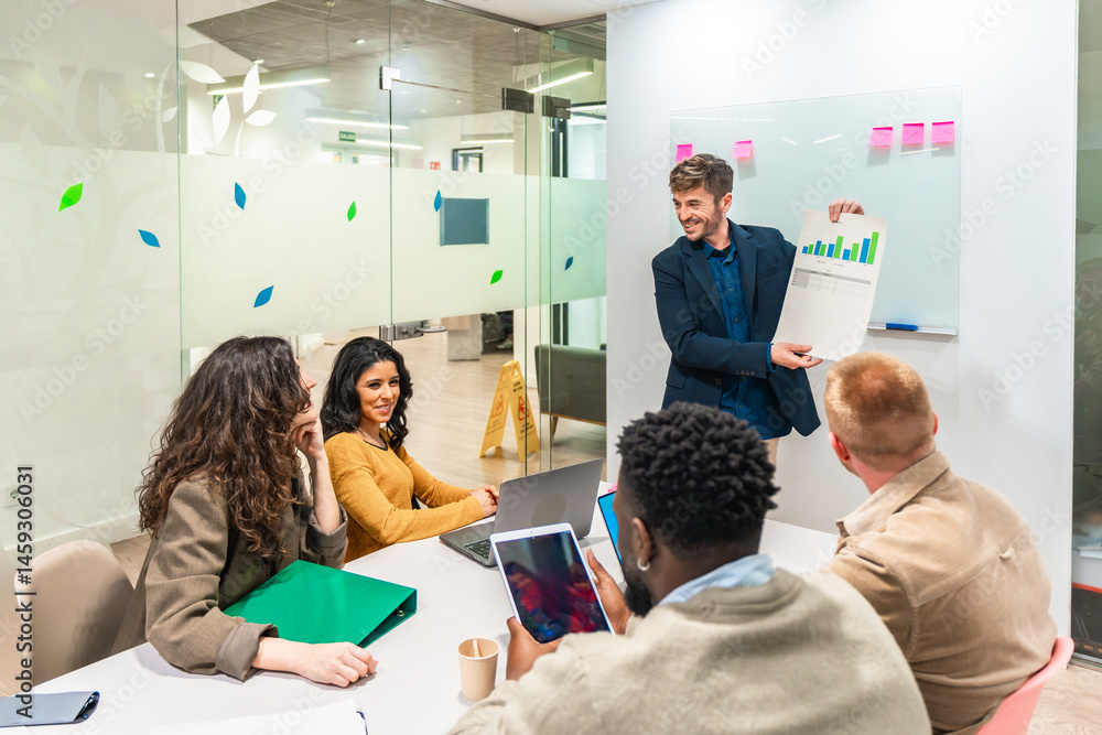 Marketing manager showing growth chart to colleagues during a meeting