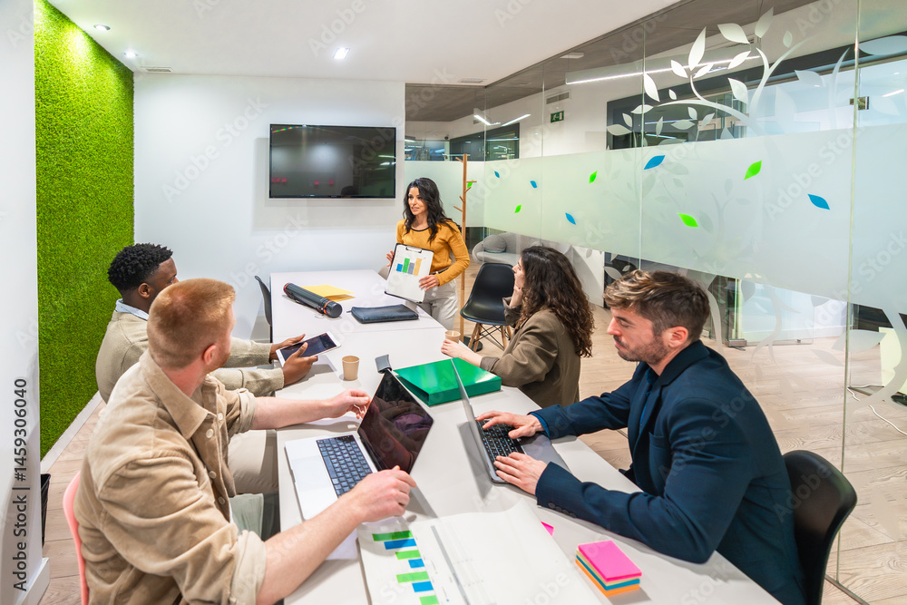 Marketing professionals collaborating on project in modern office