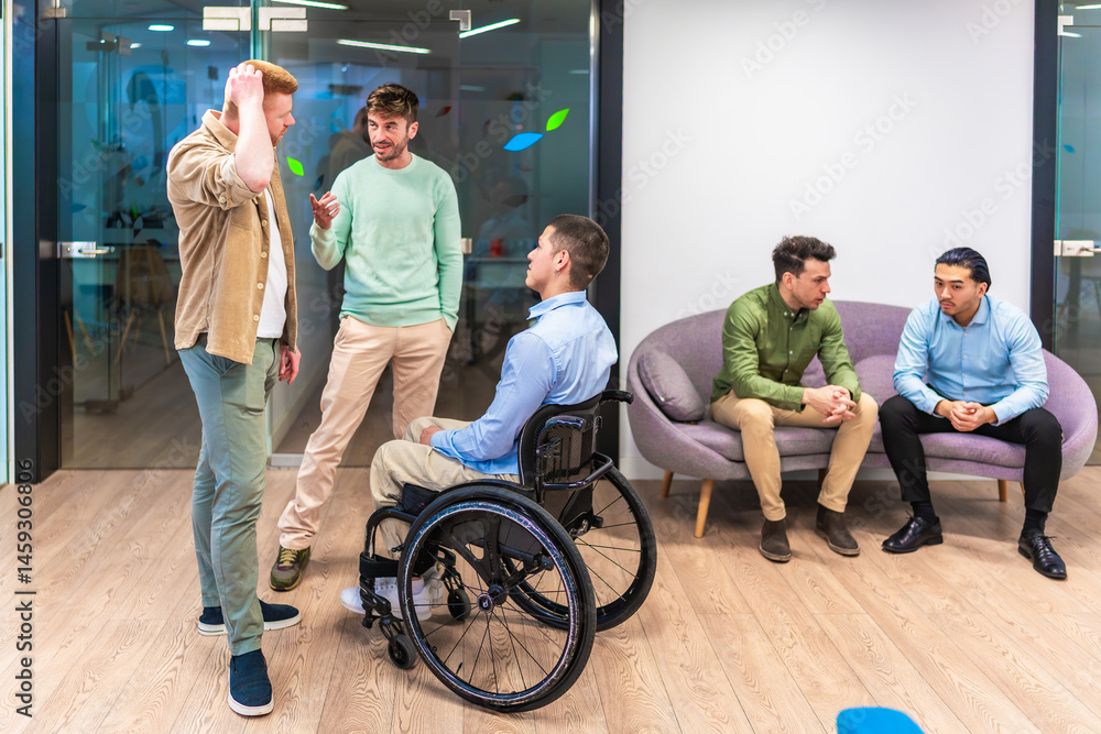 Managers discussing business strategy with disabled colleague in wheelchair in modern office