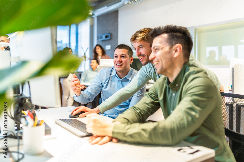 Software developers working together on a project in modern office