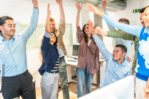 Obraz na płótnie Happy business team raising arms in office celebrating success w salonie
