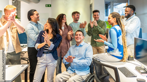 Obraz na płótnie Diverse business team applauding their colleague in wheelchair in modern office w salonie