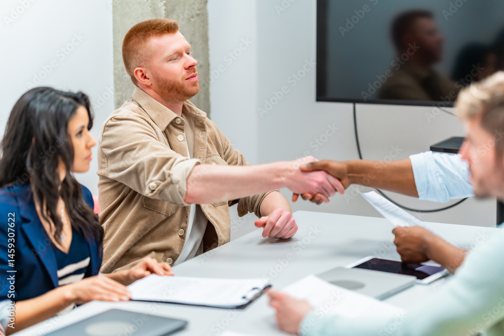 Business people shaking hands during meeting in office
