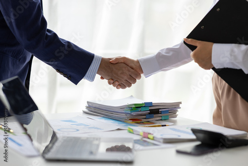 Wallpaper Mural Business people shaking hands in office. Two business partners shaking hands after signing a contract in office. Torontodigital.ca