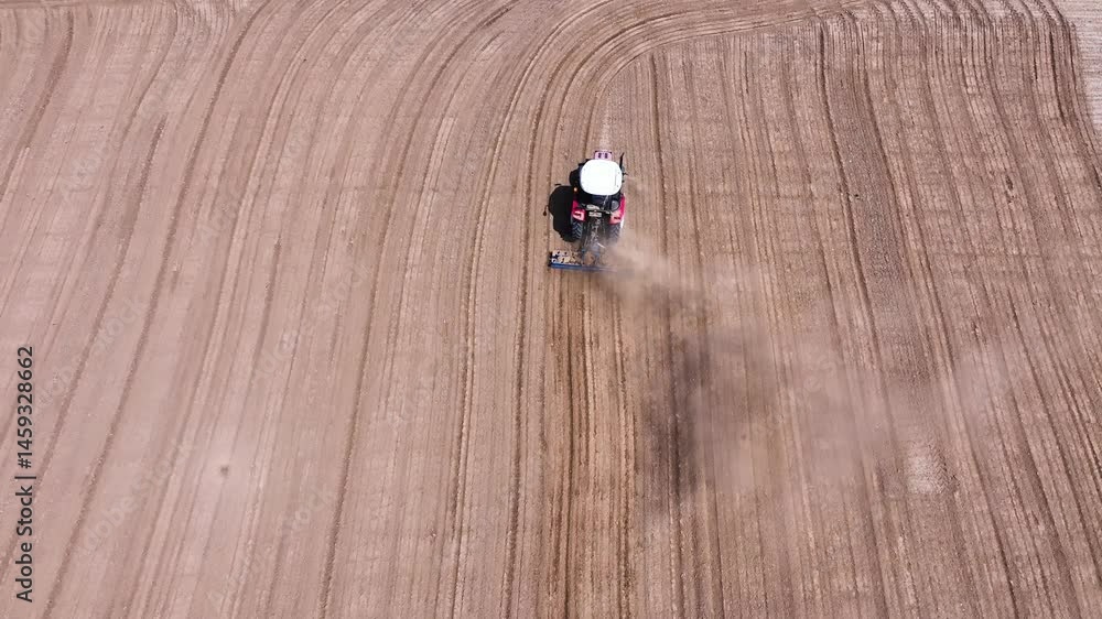 Tractor plowing the field - Red tractor plowing the field, 4k aerial shot with drone Tractor plowing the field - Red tractor plowing the field, 4k aerial shot with drone