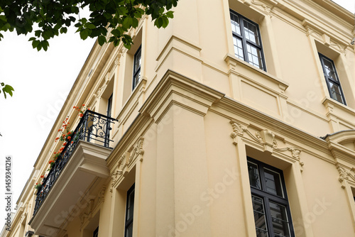 Wallpaper Mural corner of a pale yellow building with an ornate balcony and dark window frames Torontodigital.ca