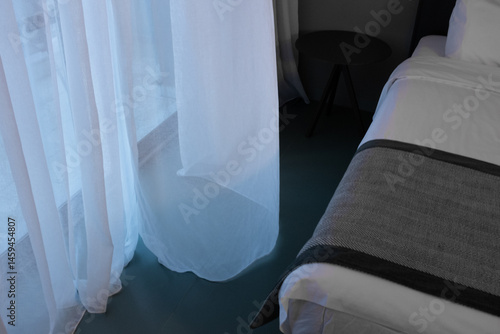 A minimalist comfortable ready elegant inviting hotel room, open window, light wind